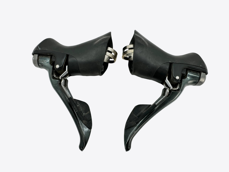 Pair of black bicycle shifters on a white background