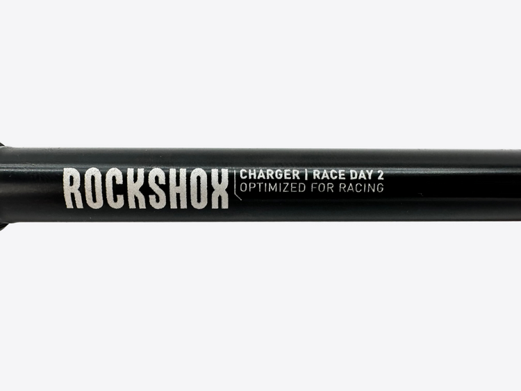 Rockshox suspension fork with 'Charger Race Day 2' text on a white background