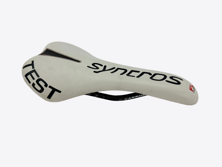 White bicycle saddle with 'syncros' branding on a white background