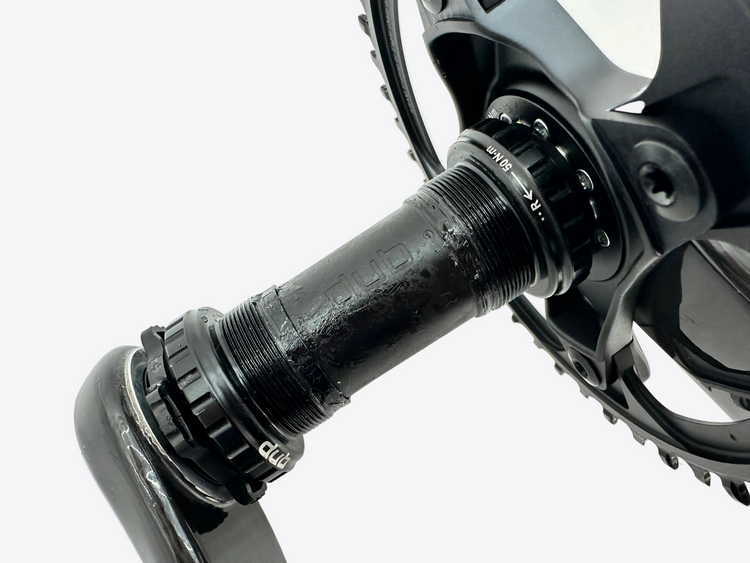Close-up of a bicycle crankset on a white background