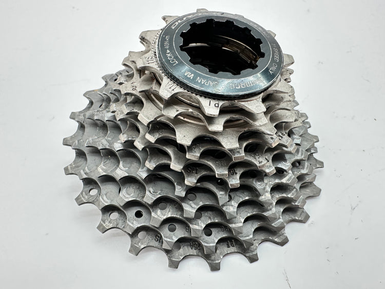 Metallic bicycle gear cassette on a white background