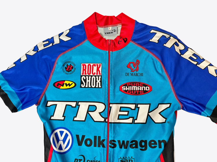 Cycling jersey with multiple brand logos on a white background