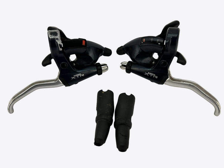 Pair of bicycle shifters with XTR branding on a white background