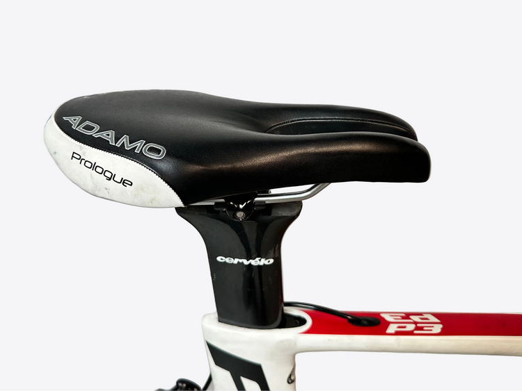 Close-up of a bicycle seat with 'ADAMO Prologue' branding on a white background