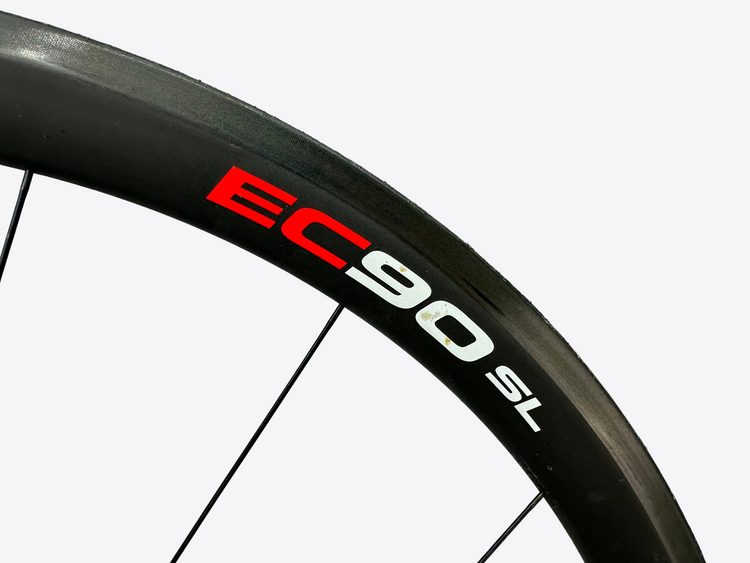 Close-up of a bicycle wheel with 'EC90 SL' branding on a white background