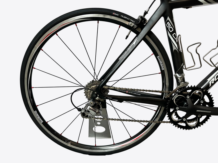 Close-up of a bicycle wheel and frame on a white background