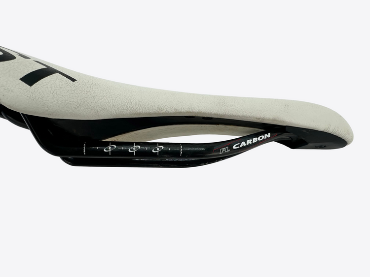 Close-up of a bicycle saddle with 'CARBON' branding on a white background