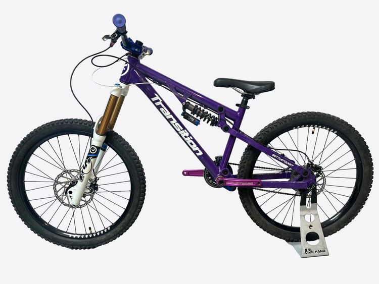 Purple bicycle with visible branding on a white background