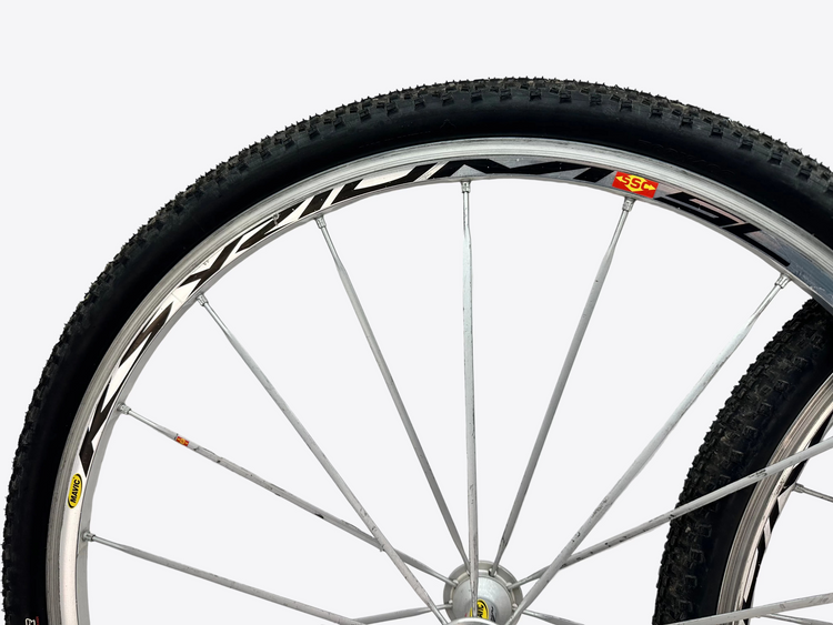 Close-up of a bicycle wheel with a white background