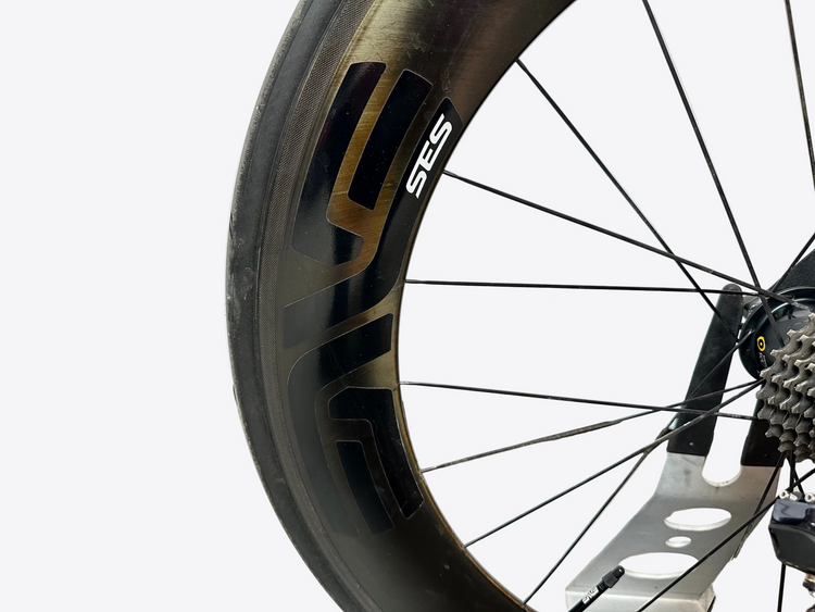 Close-up of a bicycle wheel with 'SES' branding on a blurred background