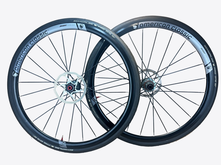 Two bicycle wheels with 'American Classic' branding on a beige background