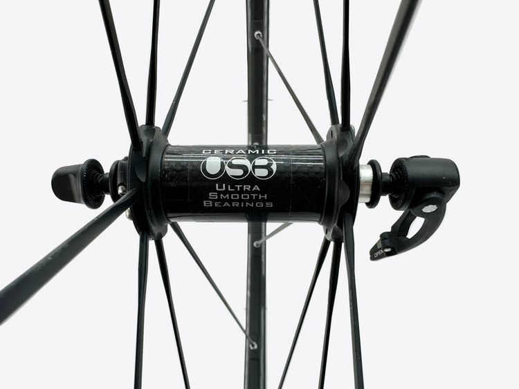 Close-up of a bicycle wheel with CeramicSpeed hub on a white background