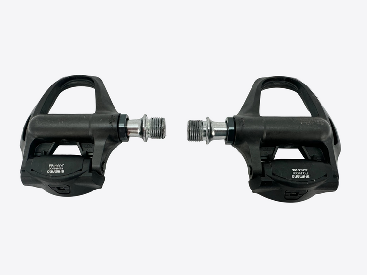 Pair of black bicycle pedals on a white background