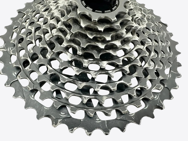 Close-up of a bicycle gear cassette on a white background
