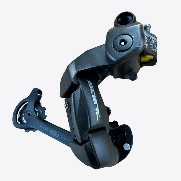 Black bicycle derailleur on a beige background