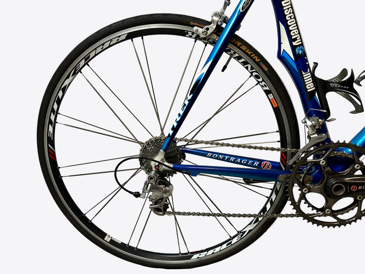 Close-up of a blue bicycle wheel with visible brand names on a white background