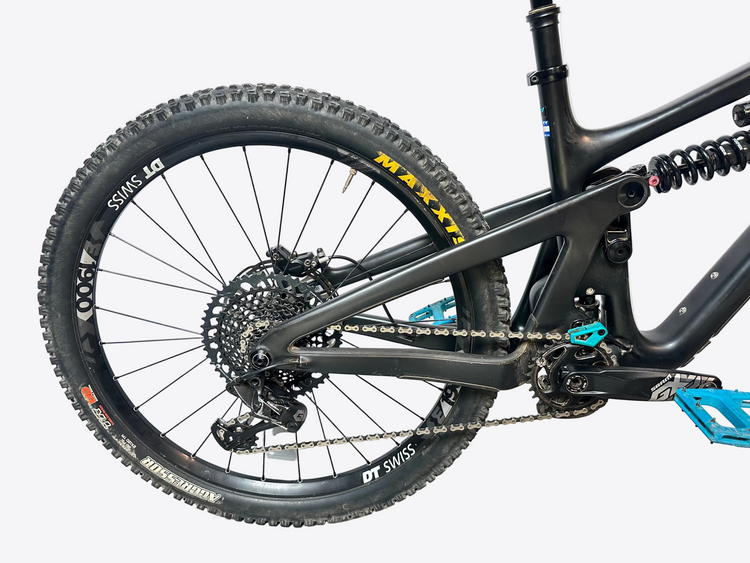 Close-up of a mountain bike with visible brand names on components against a white background