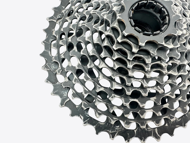 Close-up of a bicycle gear cassette on a white background