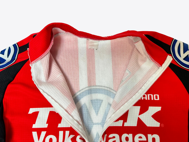 Red jacket with Volkswagen logo and text on a white background