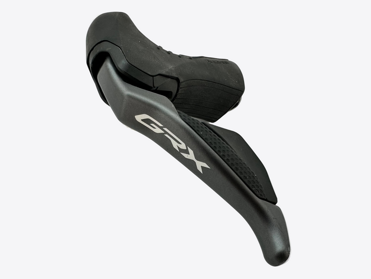 Black bicycle shifter with 'GRX' branding on a white background