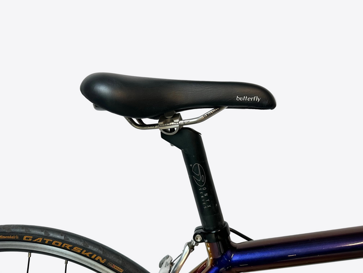 Close-up of a bicycle seat with 'butterfly' branding on a white background