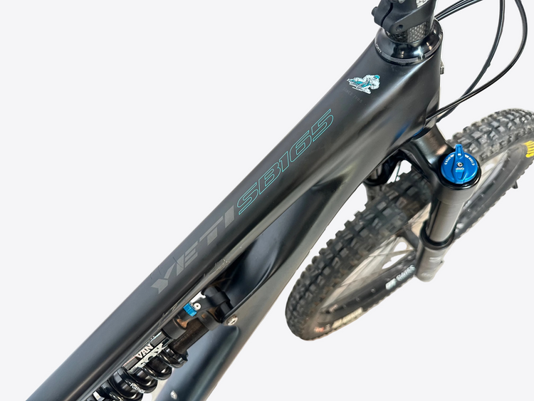 Close-up of a bicycle frame with visible branding on a blurred background