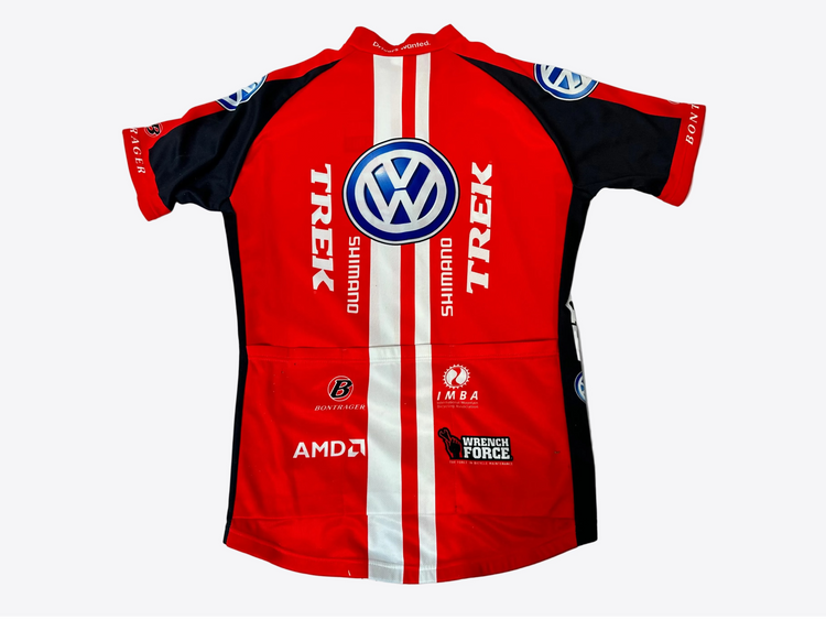 Red and black cycling jersey with multiple brand logos on a light gray background