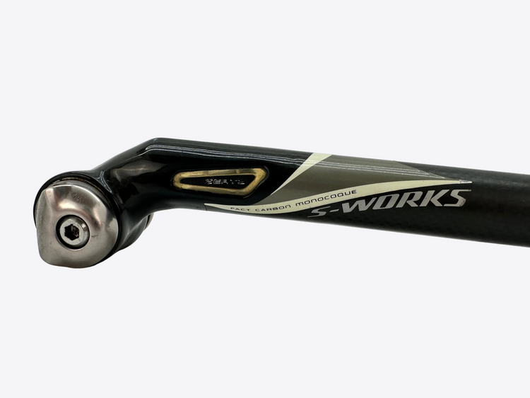 Close-up of a bicycle seat post with 'S-Works' branding on a light gray background