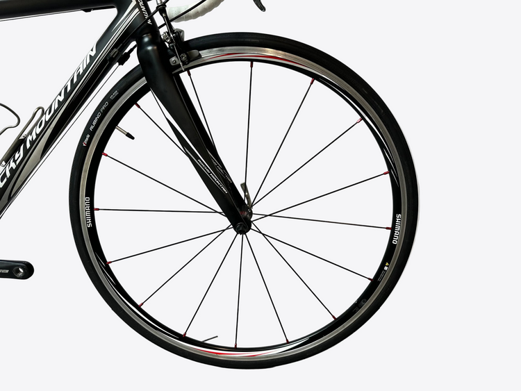 Close-up of a bicycle wheel with a white background