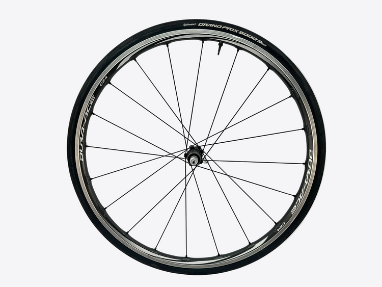 Bicycle wheel with black rim and white wall on a white background