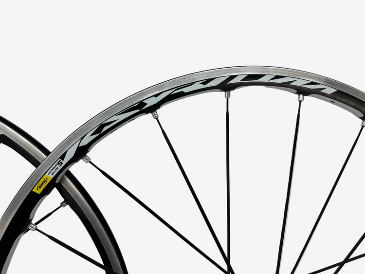 Close-up of a bicycle wheel with a white background