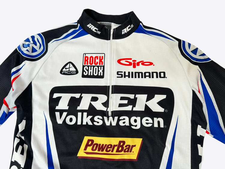 Cycling jersey with various brand logos on a white background