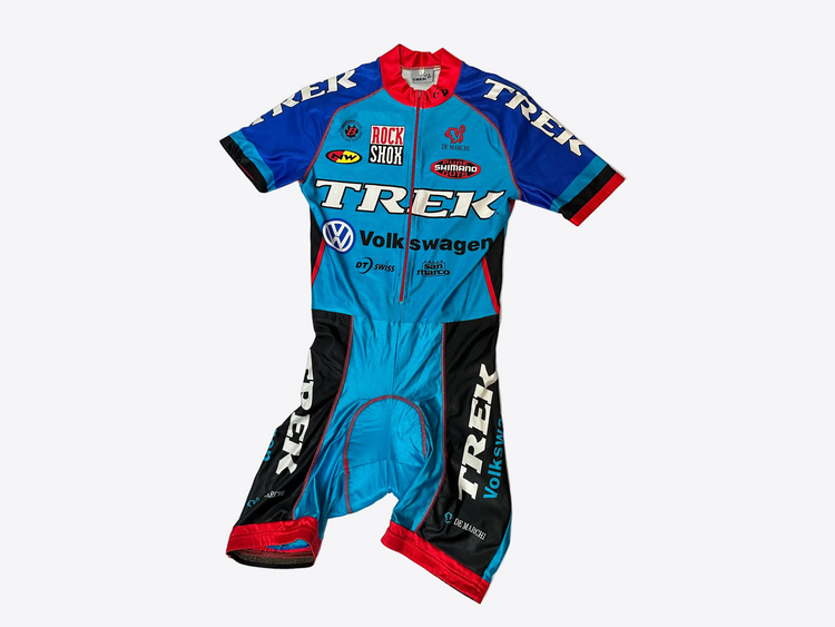 Cycling suit with multiple brand logos on a light gray background