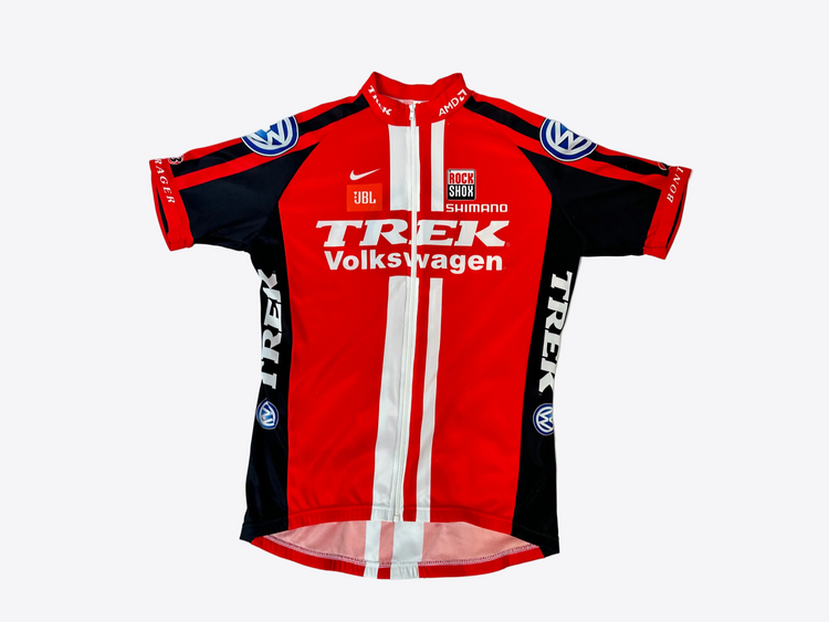 Red and black cycling jersey with visible branding on a light gray background