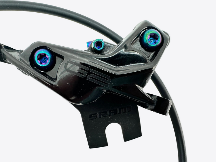 A close-up of a black SRAM G2 bicycle brake lever with blue-tinted adjustment screws on a light gray background.