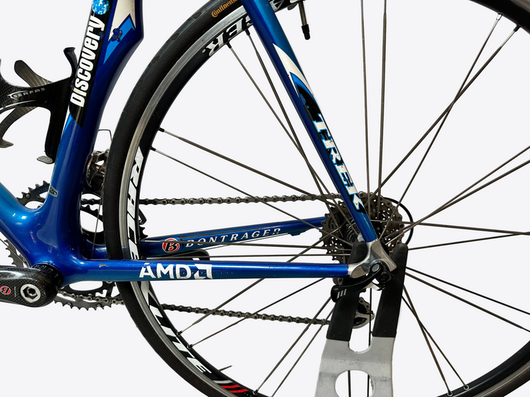 Close-up of a blue bicycle with visible branding on a white background