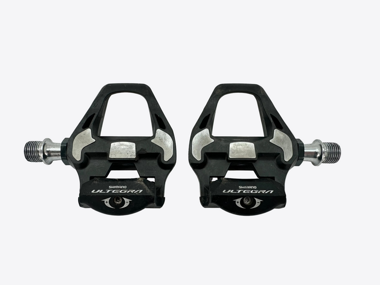 Pair of black Shimano Ultegra bicycle pedals on a white background