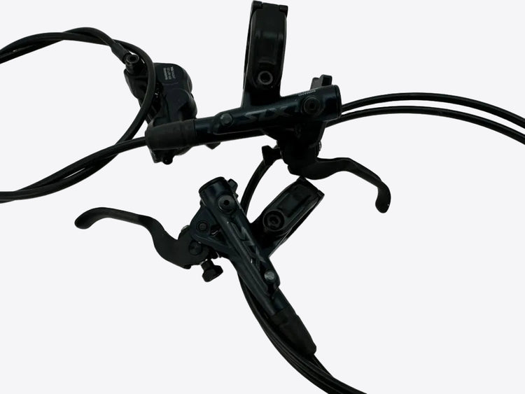 Black bicycle brake lever set with attached cables on a white background.