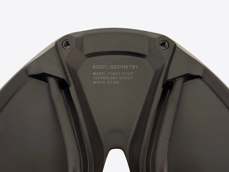 Close-up of the black textured plastic rear cover of a bicycle mirror, featuring the white printed text 'BODY, GEOMETRY' and model specifications.