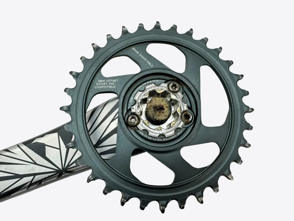 Close-up of a bicycle crankset on a white background
