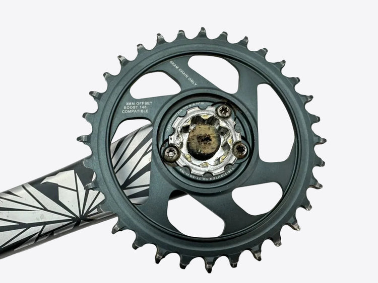 Close-up of a bicycle crankset on a white background