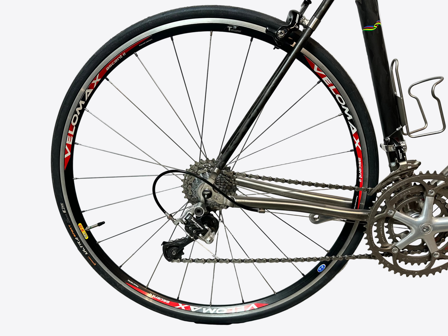 Close-up of a bicycle wheel with visible brand 'Velomax' on a white background