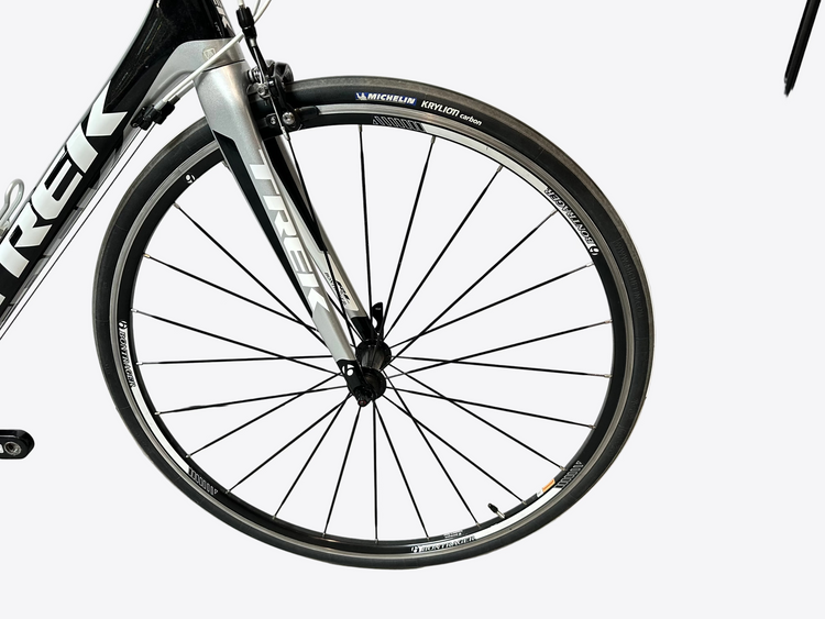 Close-up of a bicycle wheel with 'Trek' branding on a white background