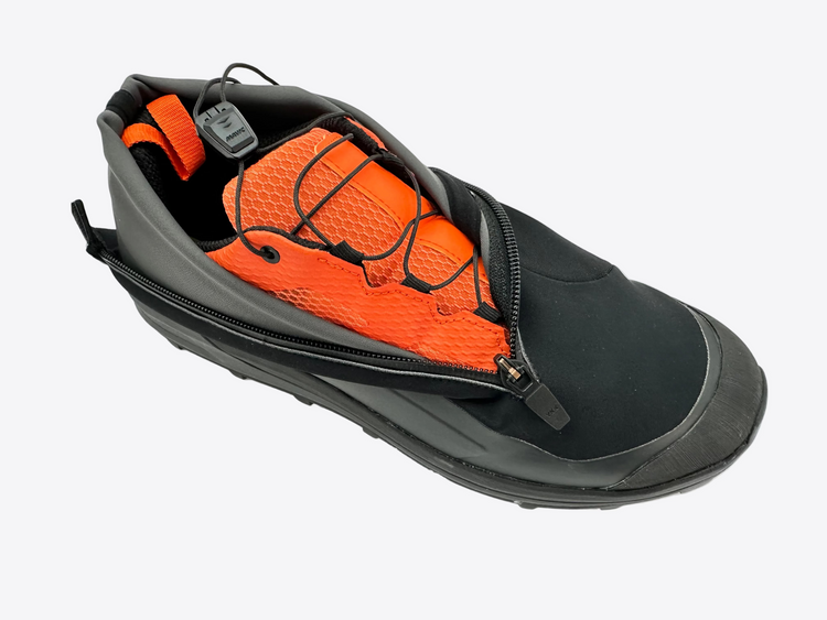 Black and orange shoe with a zipper on a white background