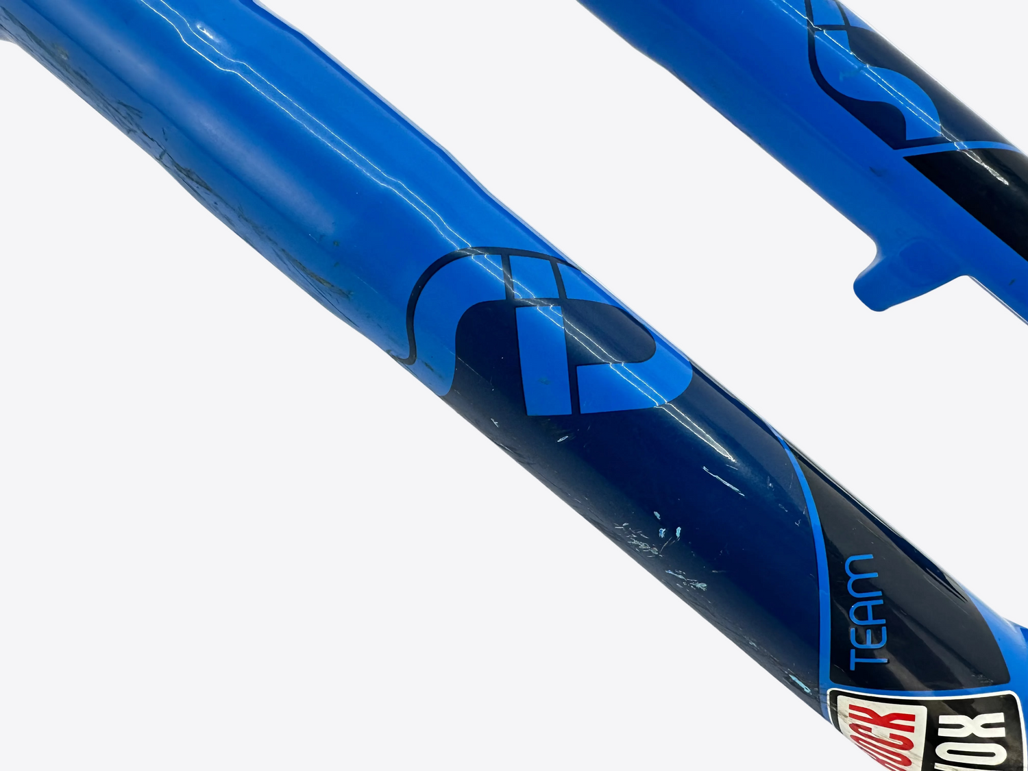 Close-up of a blue and black bicycle frame with 'FOX' branding on a white background