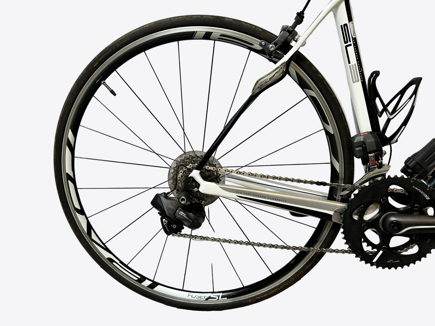 Close-up of a bicycle wheel and chain on a white background