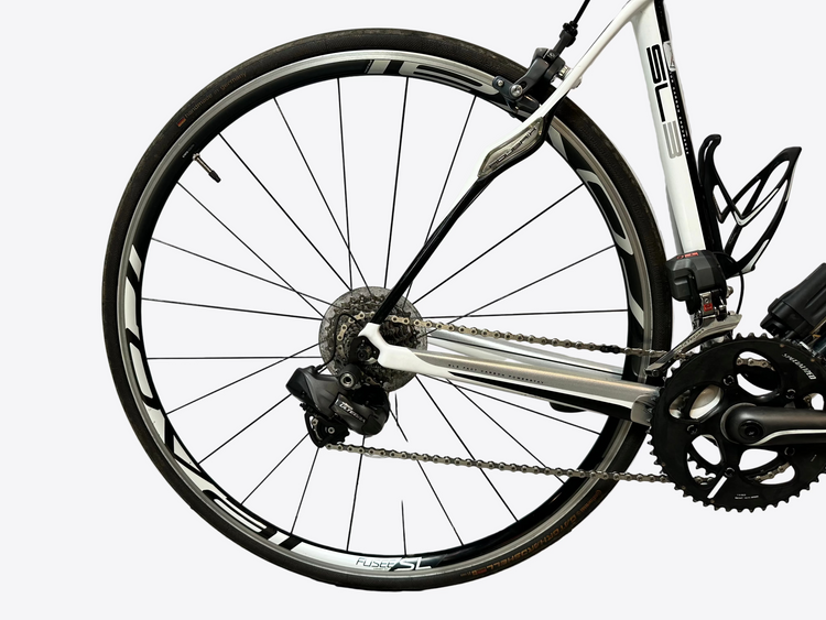 Close-up of a bicycle wheel and chain on a white background