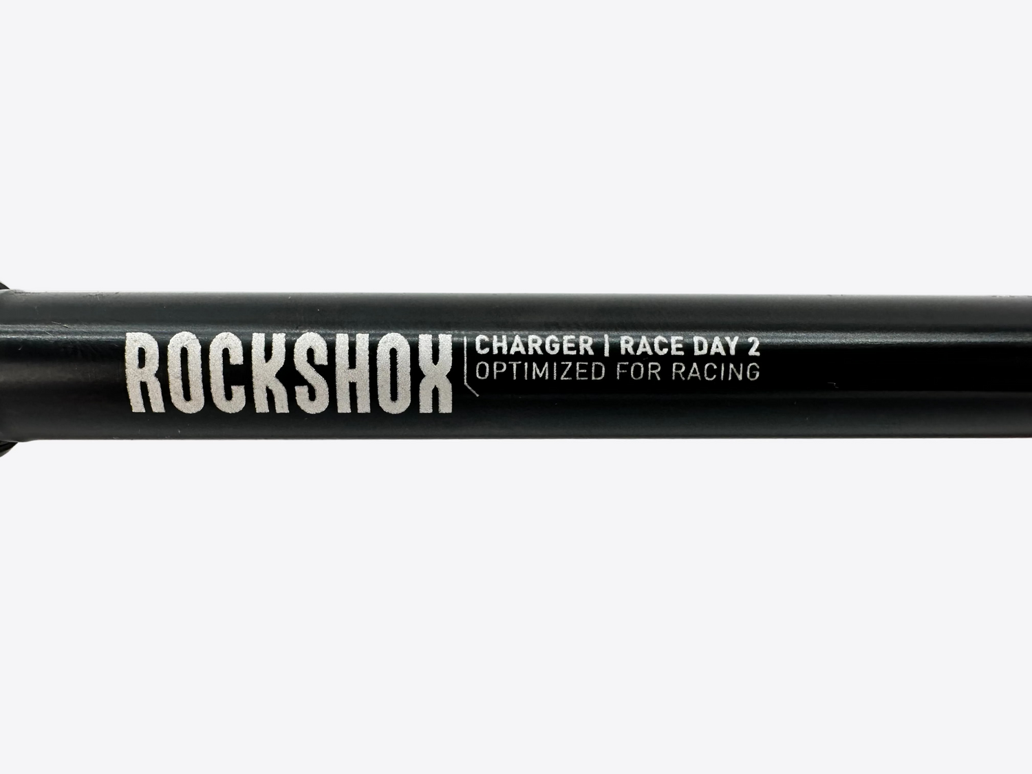 Rockshox suspension fork with 'Charger Race Day 2' text on a white background