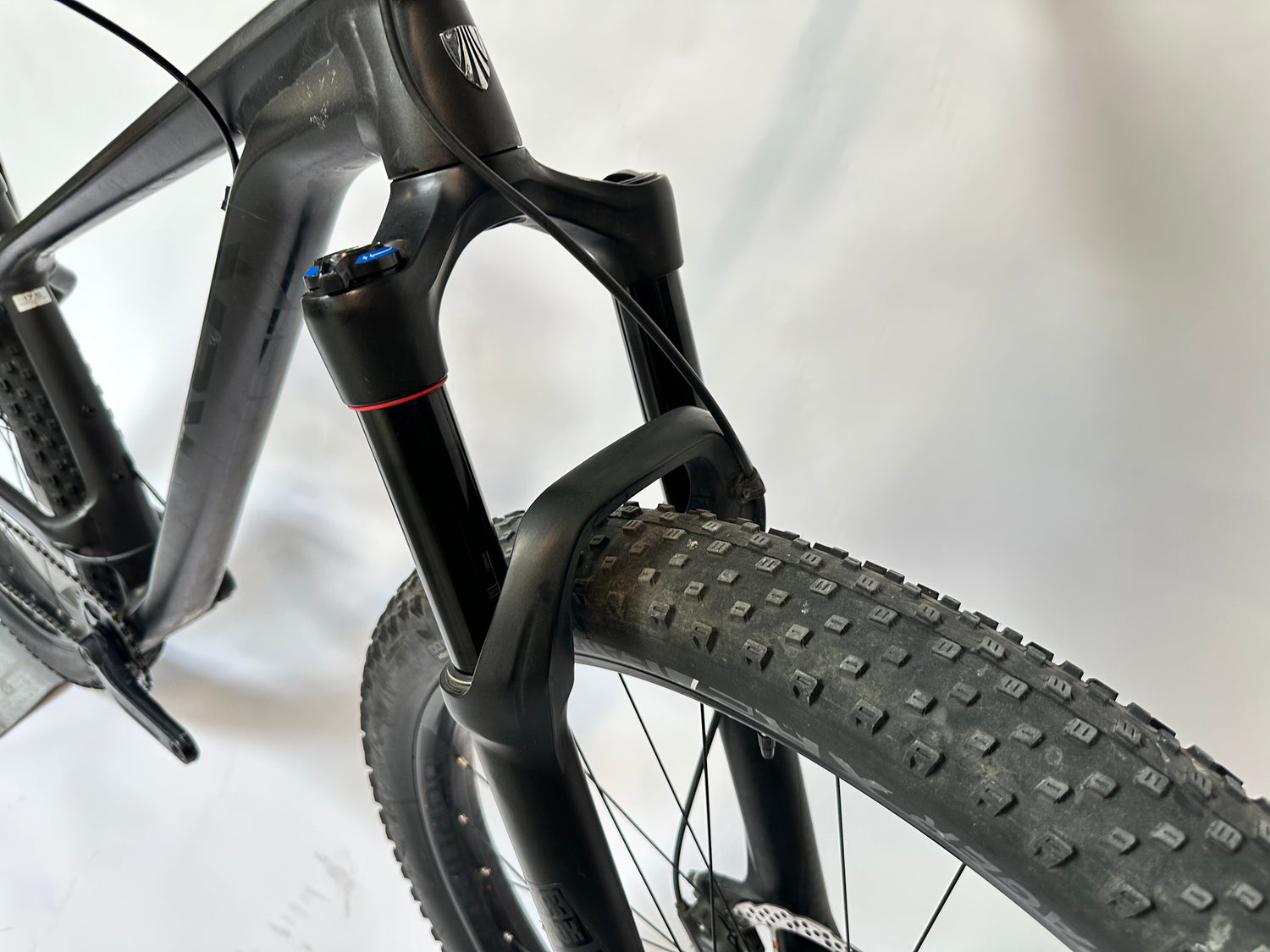 Close-up of a bicycle fork and tire on a white background
