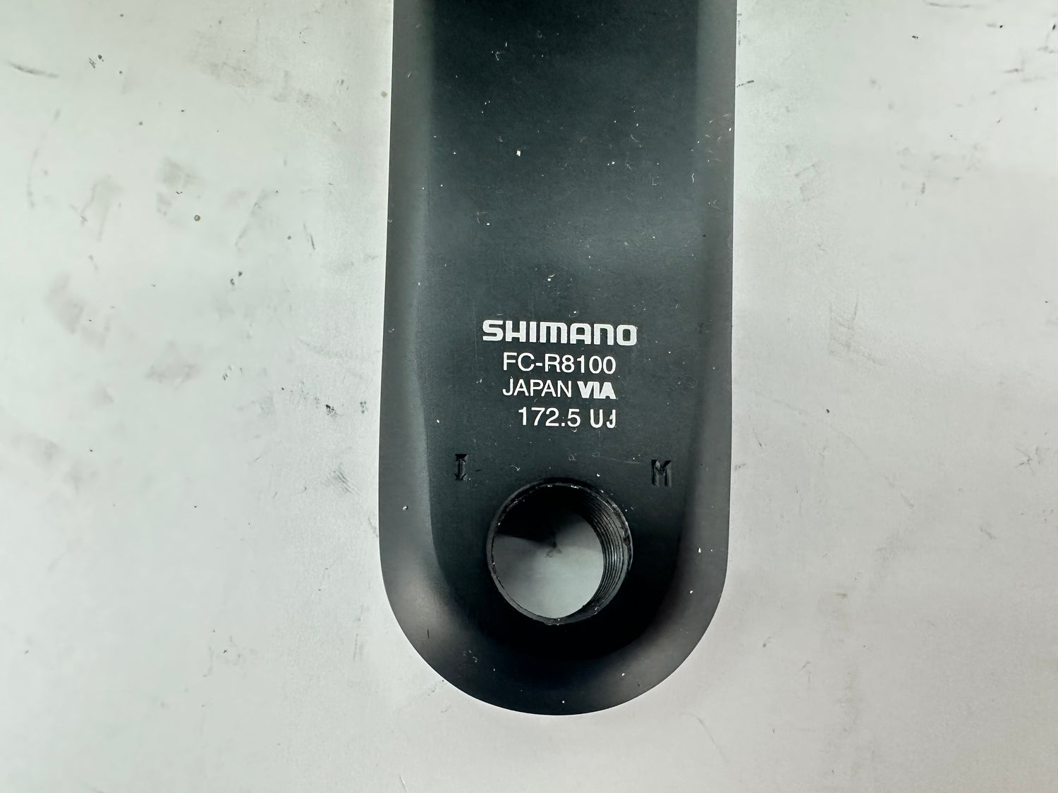Shimano FC-R8100 component on a gray background